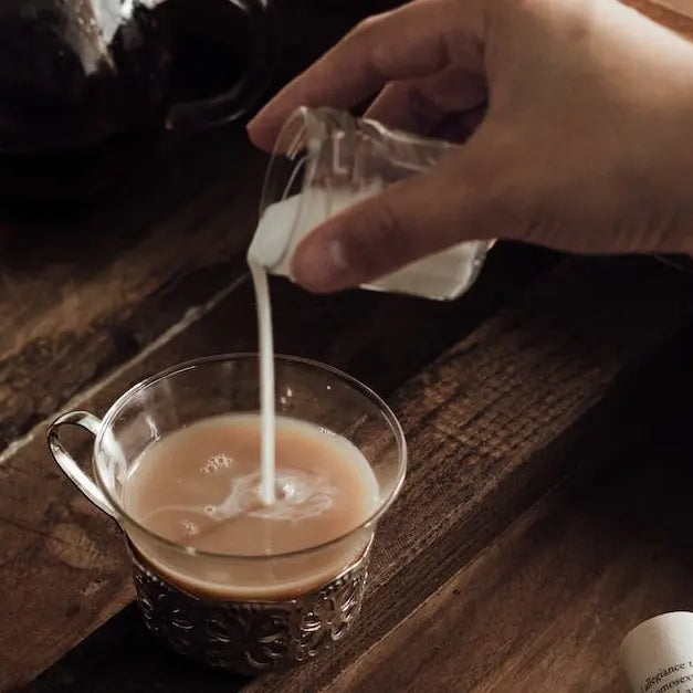 Pouring buttermilk into a coffee.