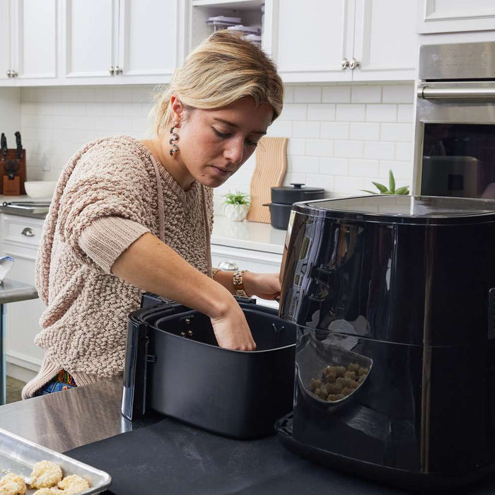 Girl using a pressure cooker air fryer combo