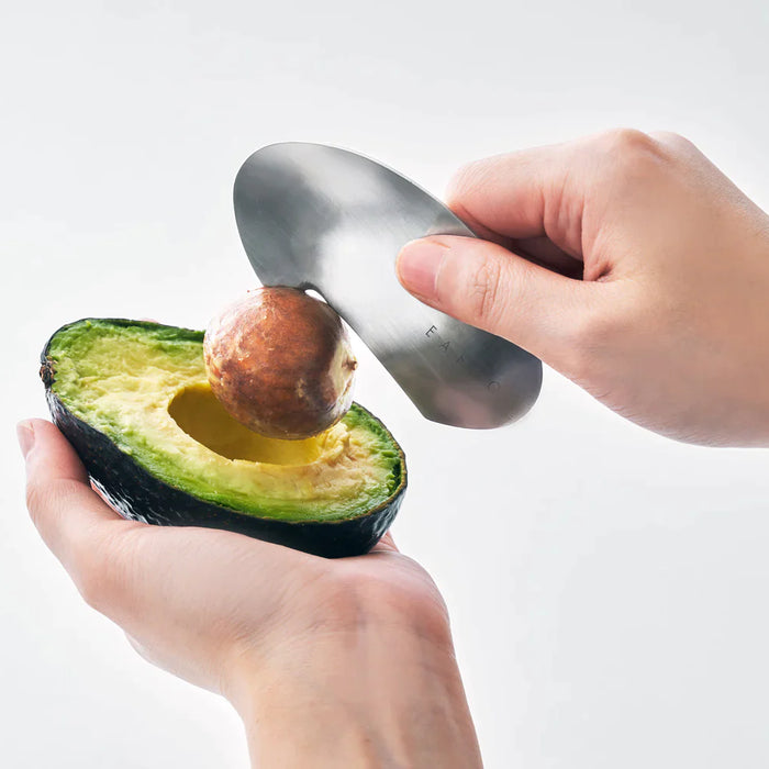 An avocado sliced by an avocado slicer.