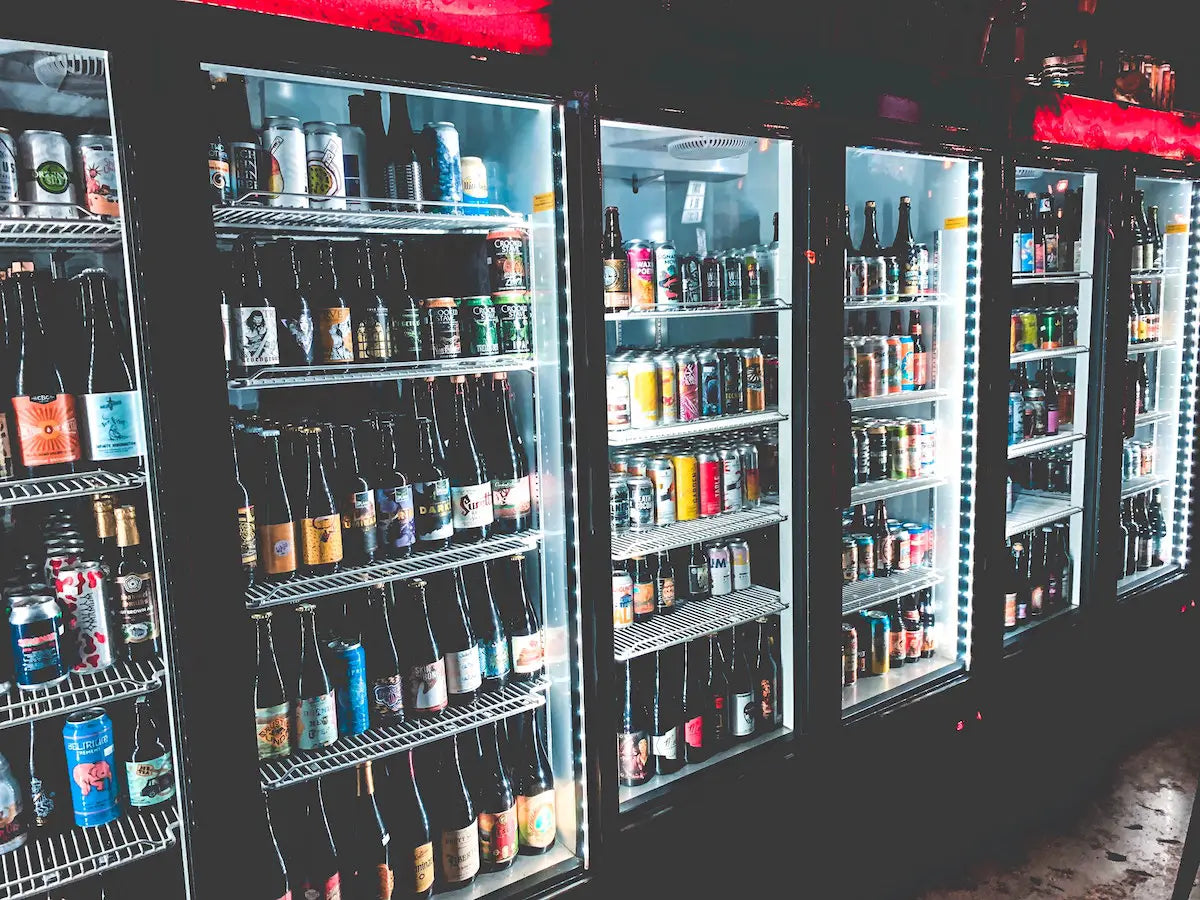 Selection of beers in a supermarket store's fridge.