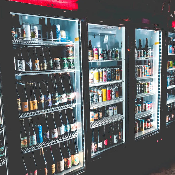 Selection of beers in a supermarket store's fridge.