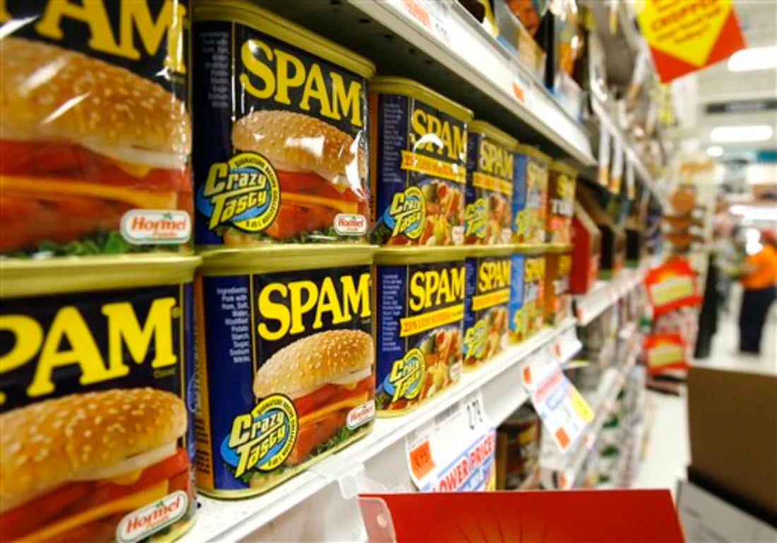 Cans of Spam on a supermarket shelf.