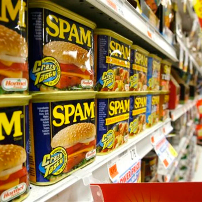 Cans of Spam on a supermarket shelf.