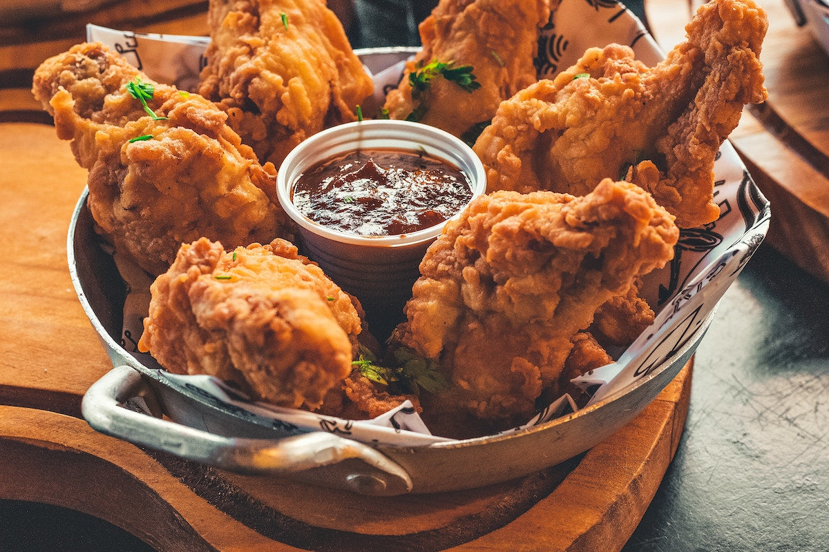 Crispy fried chicken with sauce in a serving bowl.