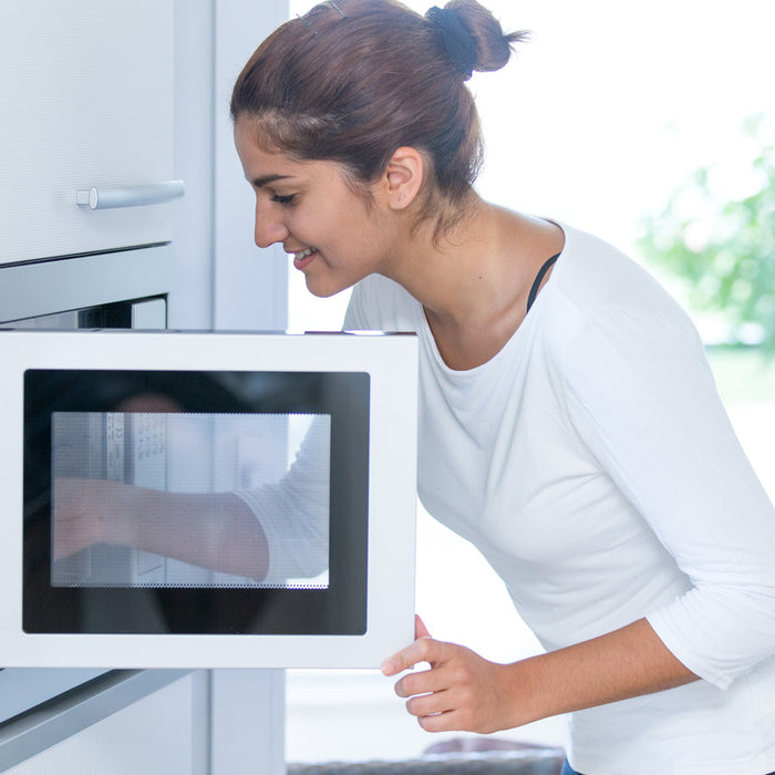 Girl using a microwave