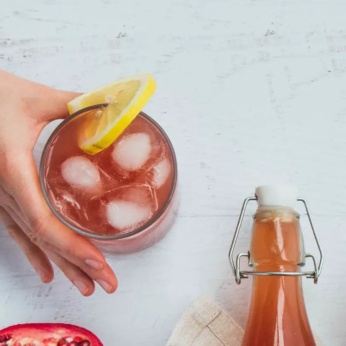 A glass of Kombucha with a lemon.