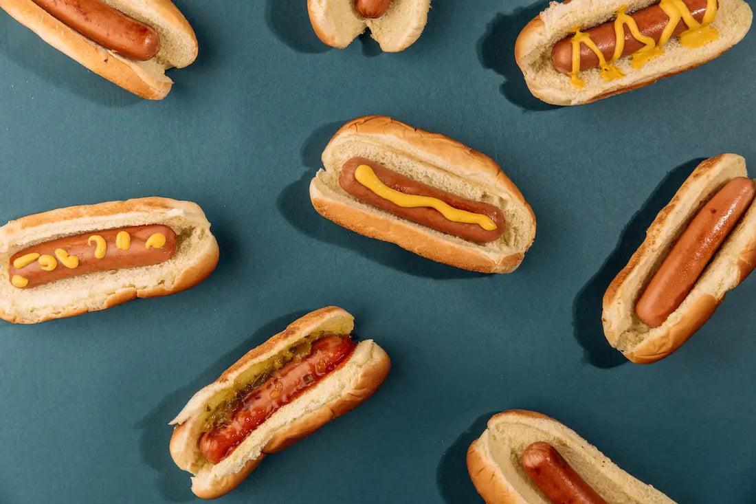 Hot dogs with various mustards on top.