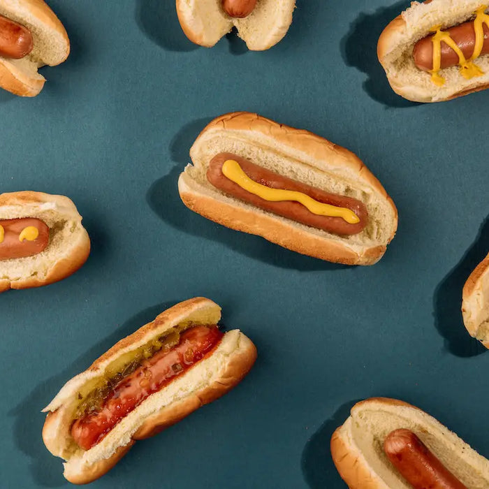 Hot dogs with various mustards on top.