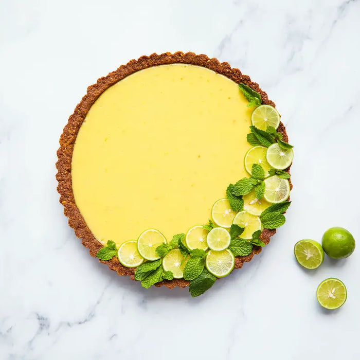 Key lime pie on a marble kitchen counter.