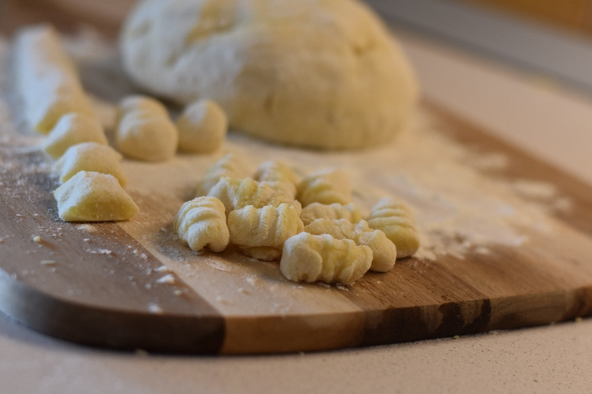 Making gnocchi on a gnocchi board.