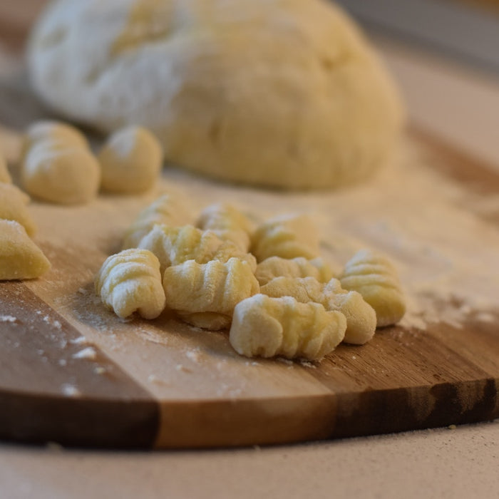 Making gnocchi on a gnocchi board.