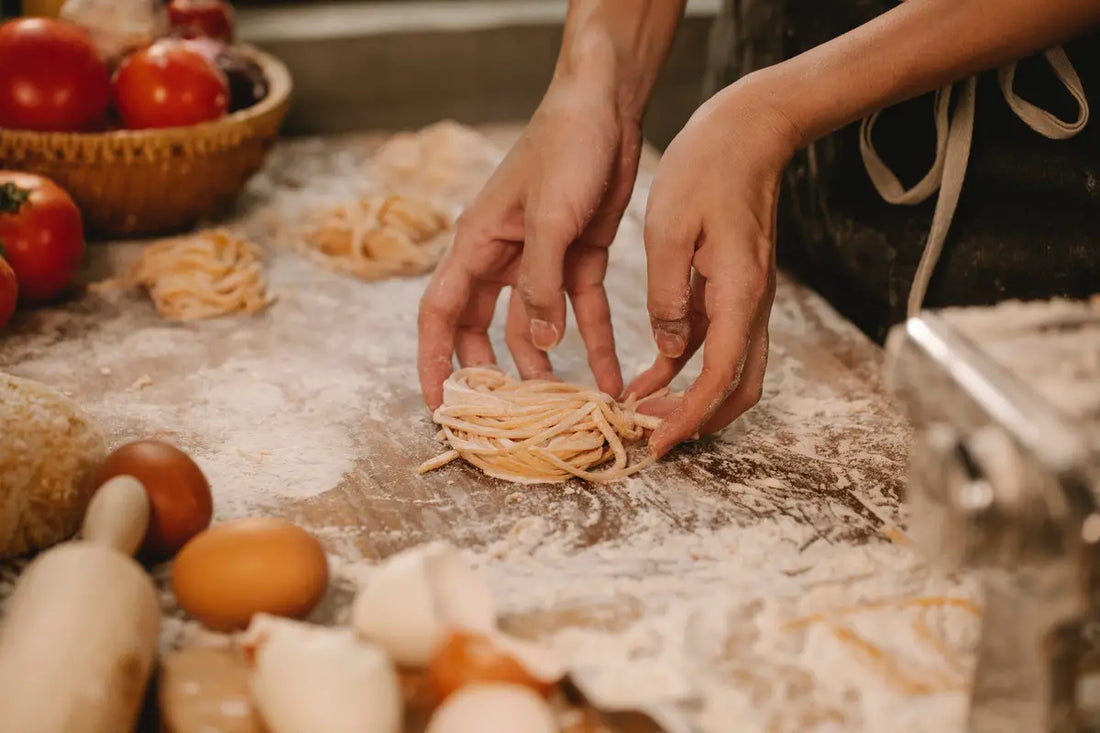 Crafting noodles on a noodle board.