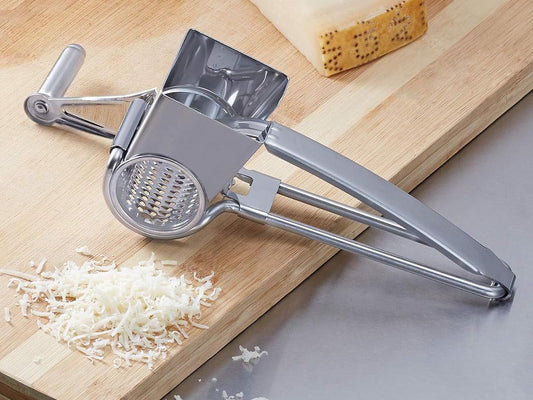 Grated parmesan cheese on a board with a grater.