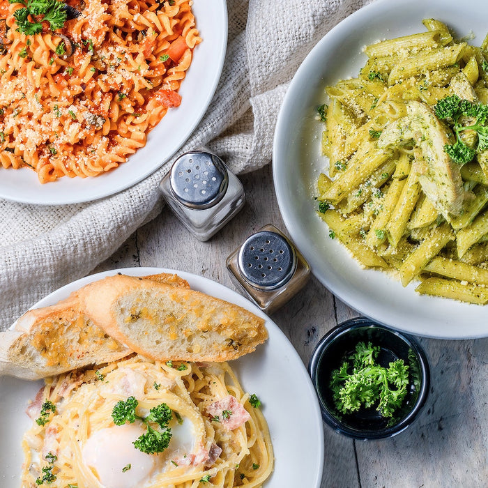 Flatlay of different pasta dishes.