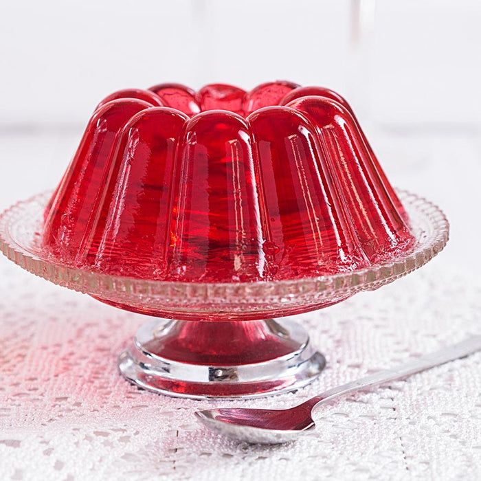 Red jelly on a cake stand.