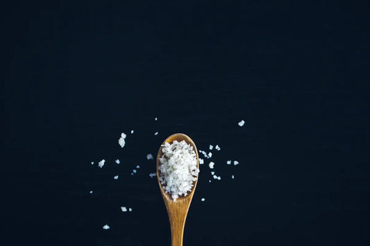 Salt on a wooden spoon.