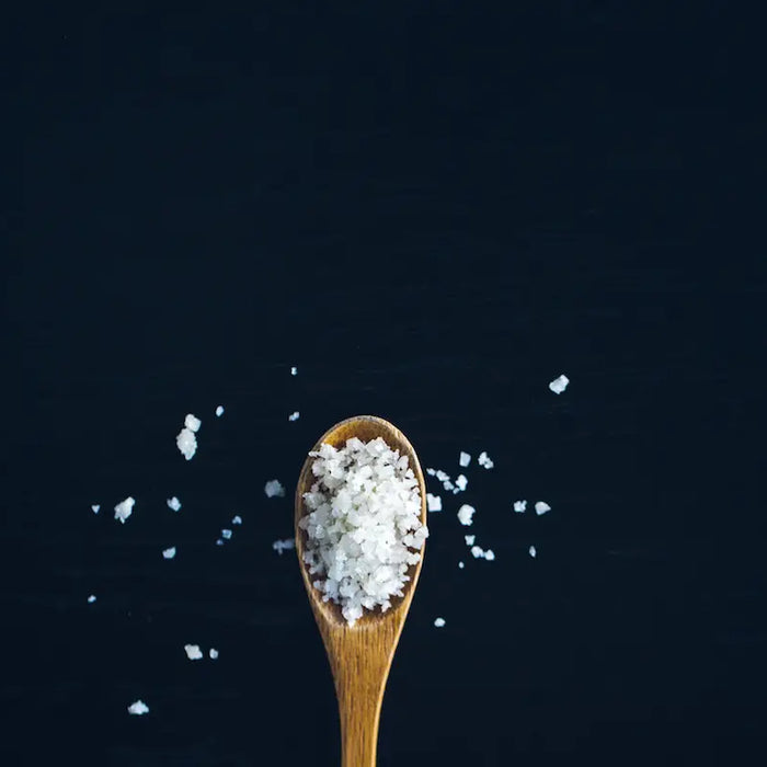 Salt on a wooden spoon.