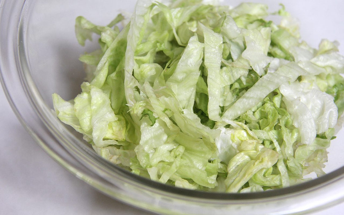Shredded lettuce in a bowl.