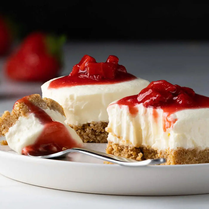 Strawberry mini cheesecakes on a plate.