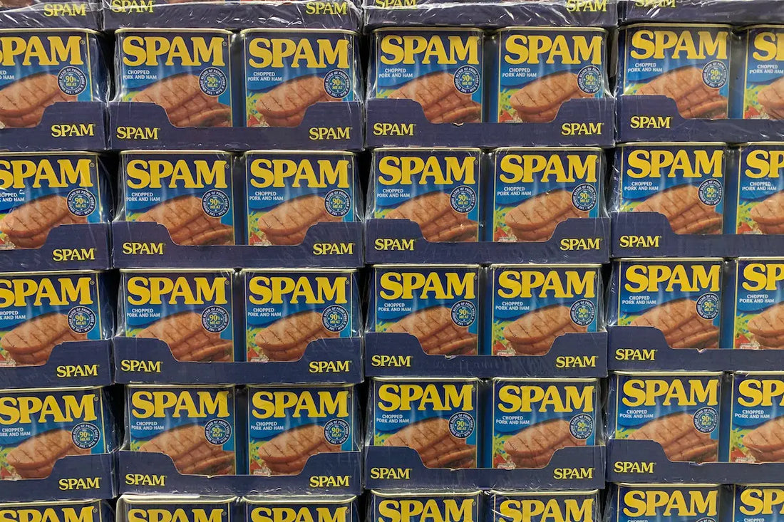 Tins of spam in a supermarket shelf.