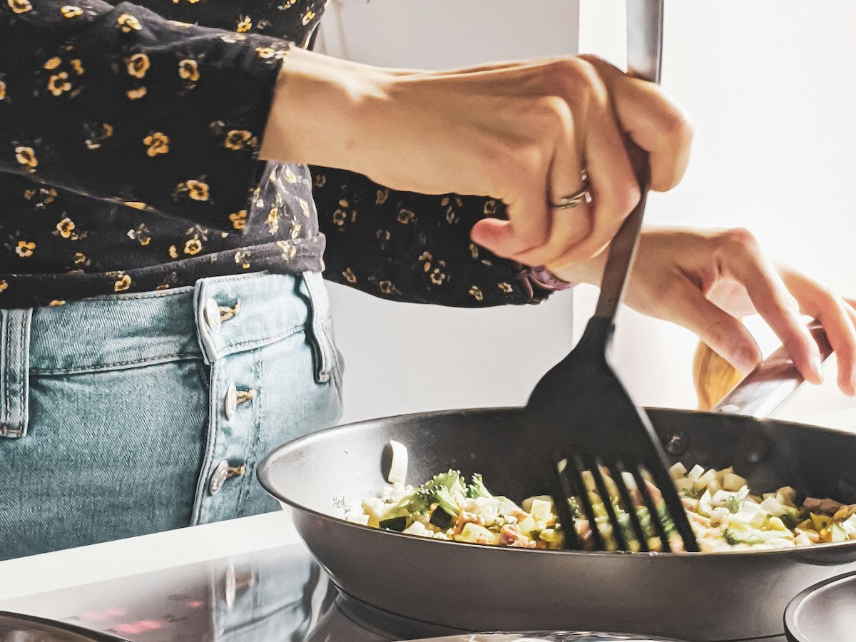 Using a silicone spatula in a frying pan.